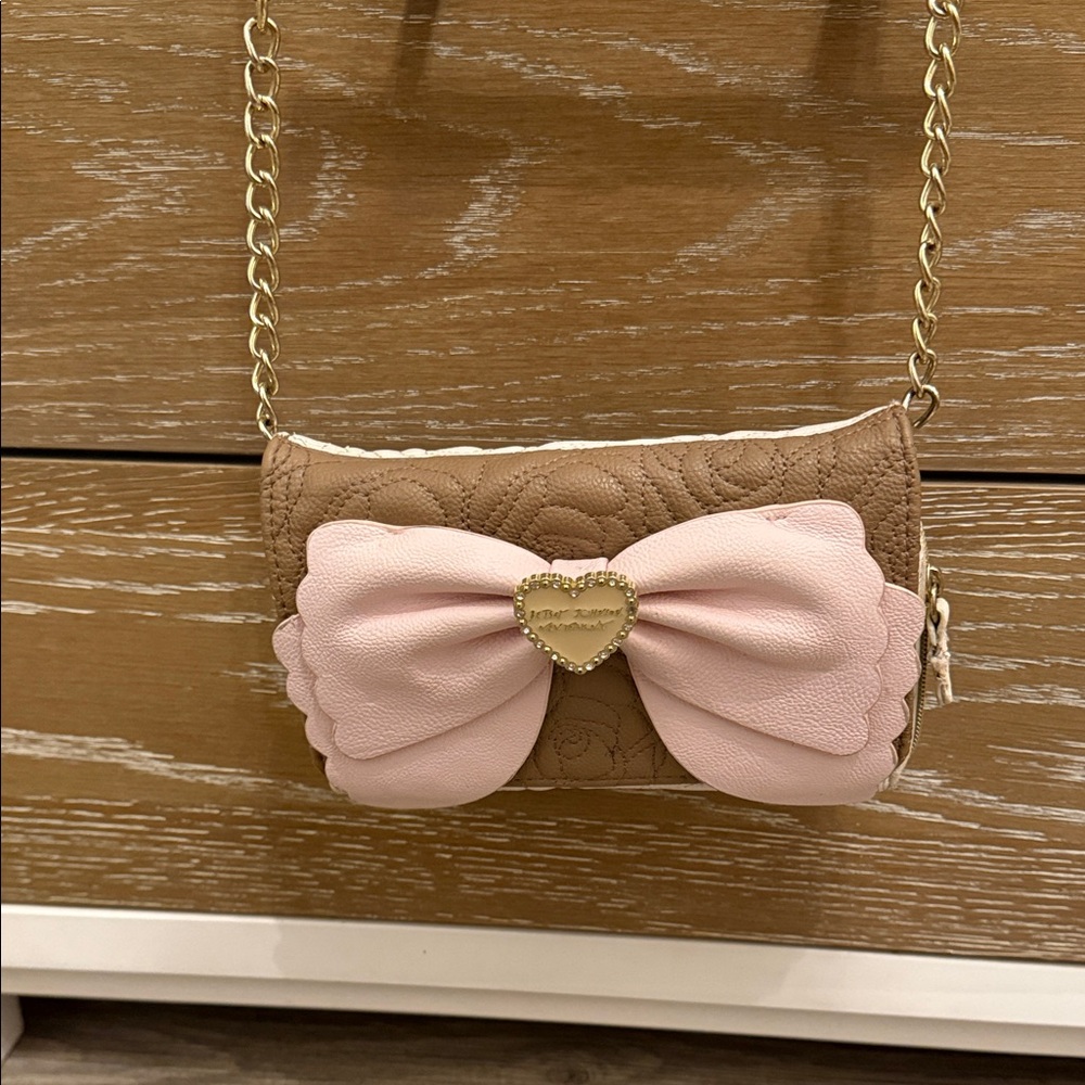 Betsy Johnson’s brown and beige pink pow cross body